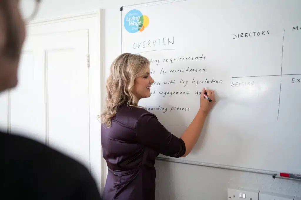 Lydia Boyden writing on whiteboard, About Us, Red Kite HR Services